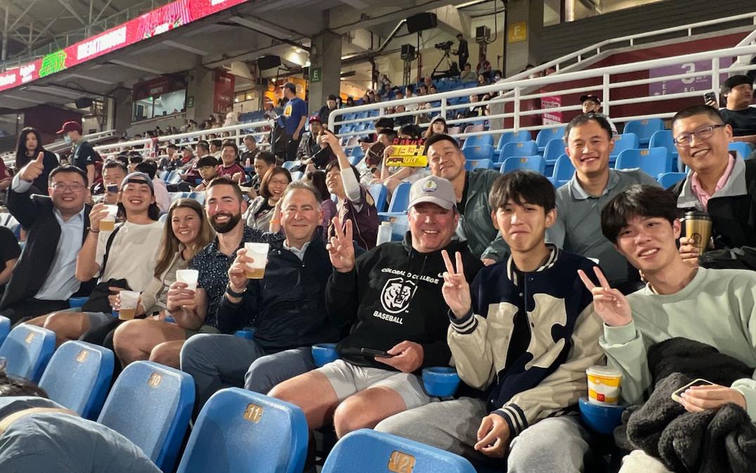 2024-Taiwan-Technical-Mtgs, group of people sitting together at-the-ballpark flashing peace signs