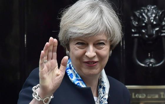 British Prime Minister Theresa May waves goodbye