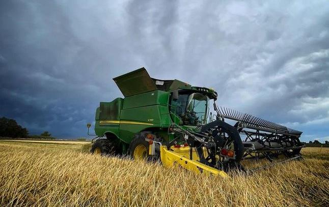 CA Harvest, combine in field, stunning line of white clouds in background, Kurt Richter photo