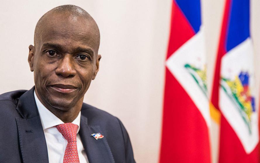 Jovenel Moise, president of Haiti, black man wearing suit in front of three Haiti flagsc, ABC News photo