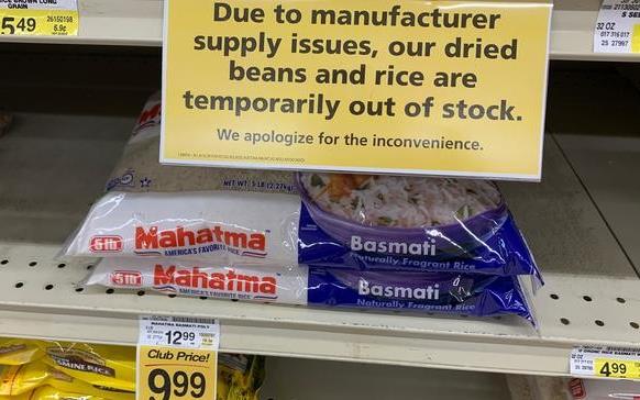 Two bags of rice on near-empty grocery store shelves