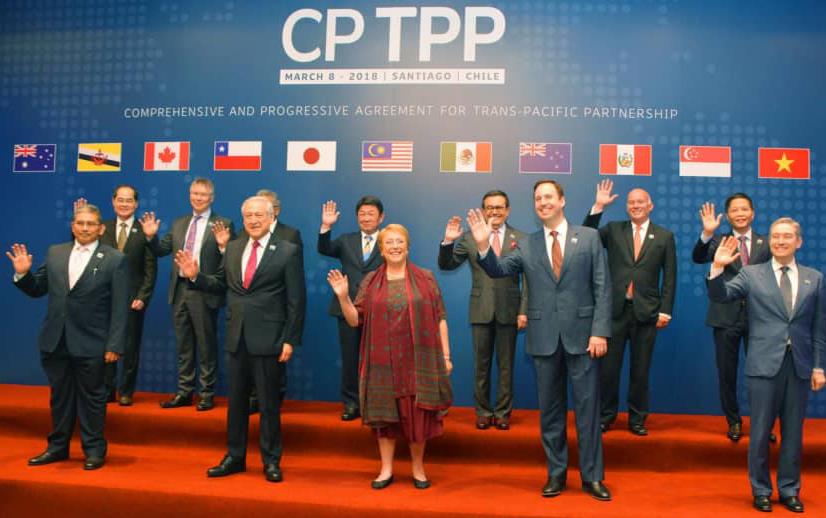 Group shot of CPTPP trade partners standing on stage beneath respective country