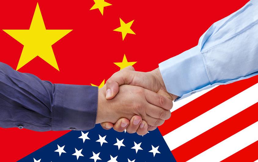 Handshake over US & China flags