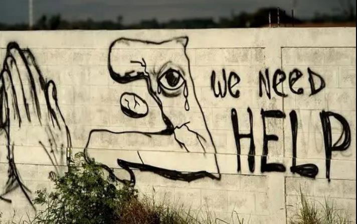 We-Need-Help graffiti with praying hands in Haiti