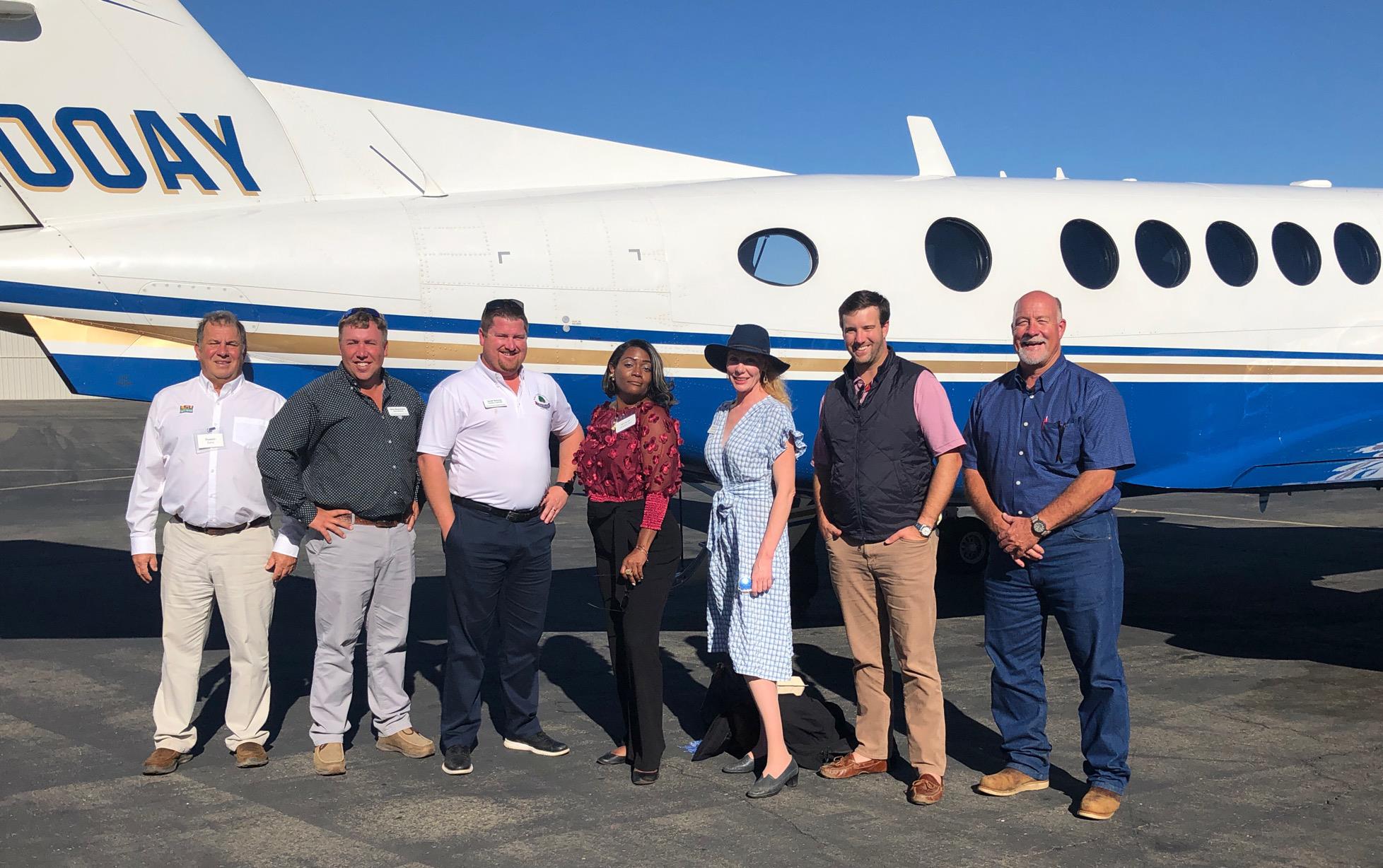 2021-23 Leadership CA Session, group shot on the tarmac in front of small plane