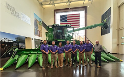 2027 Ldrshp Class at John Deere, group shot in front of combine