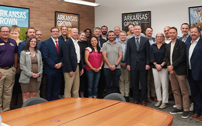 AR Ag Secy Wes Ward & Intl Ag Attaches, group shot in room w/AR Grown posters
