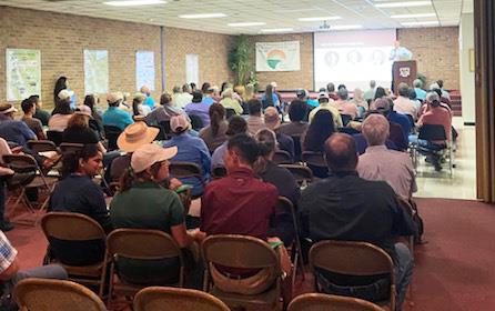 2023 Beaumont Field Day, crowd seated in front of stage where man stands at dias