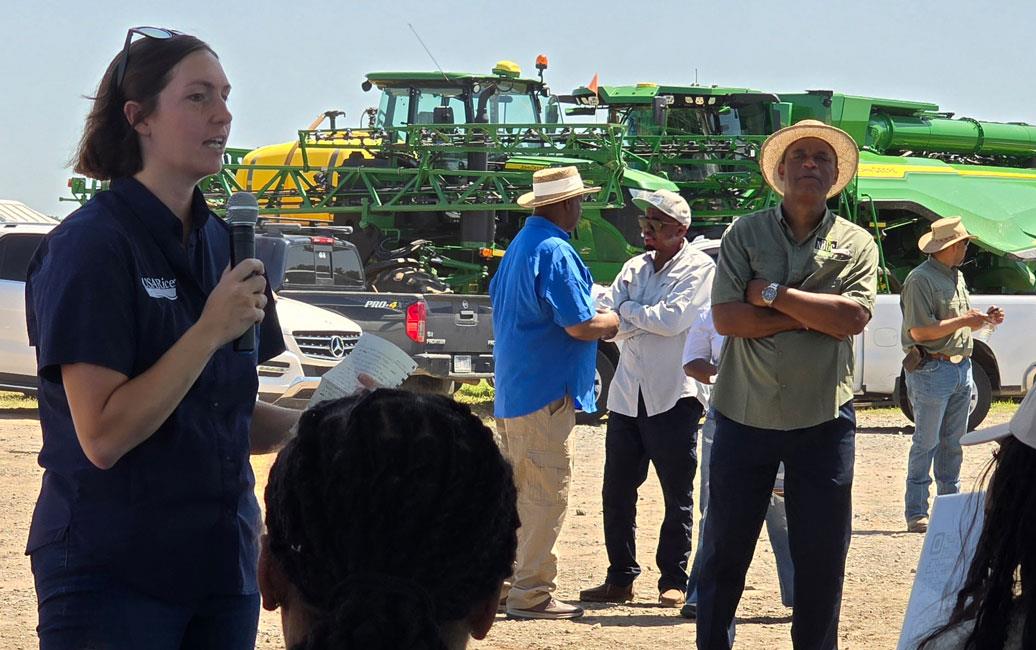 NBGC-Field-Day,-Emily Woodall-addresses-crowd with farm equipment in background