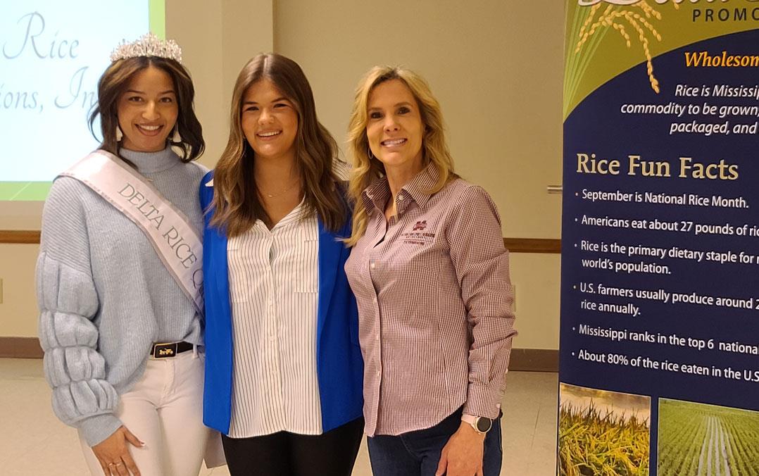 New-MS-Rice-Queen stands next to a former queen and the local Extension agent