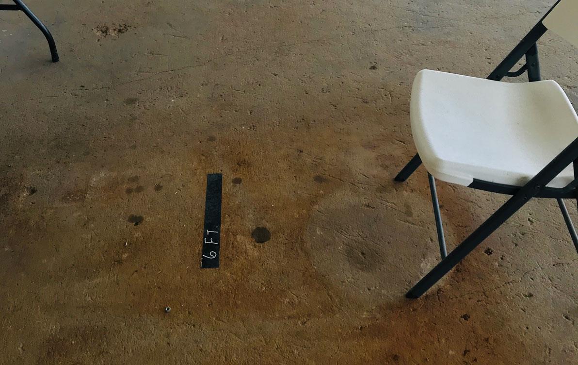 Whiate fold-out chairs set 6 feet apart for social distancing