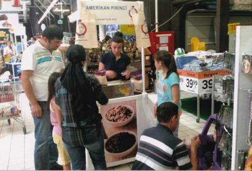 family tries sample of wild rice at store