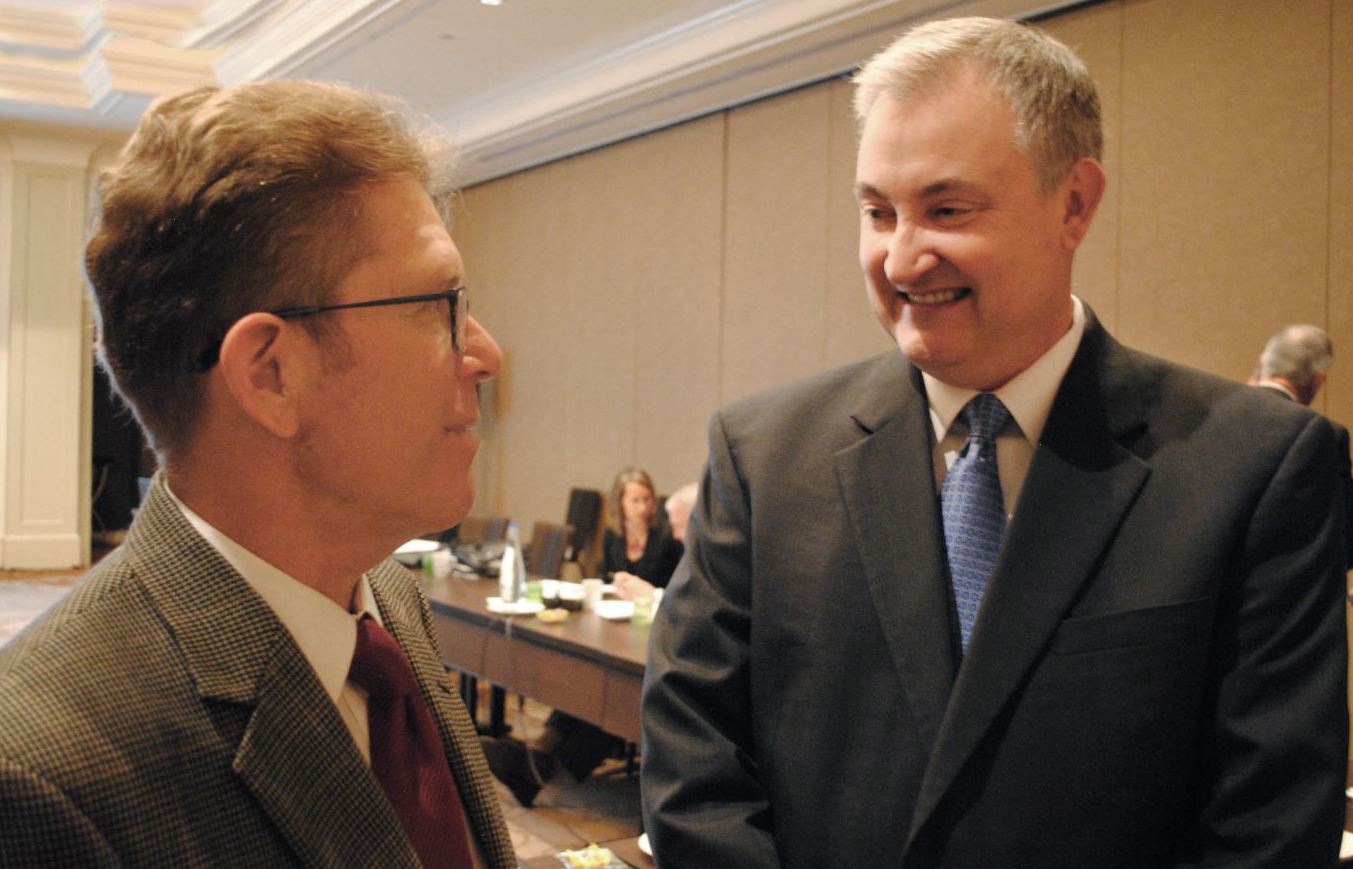 two men talk at commitee