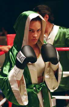 Female boxer wearing silk robe & black boxing gloves