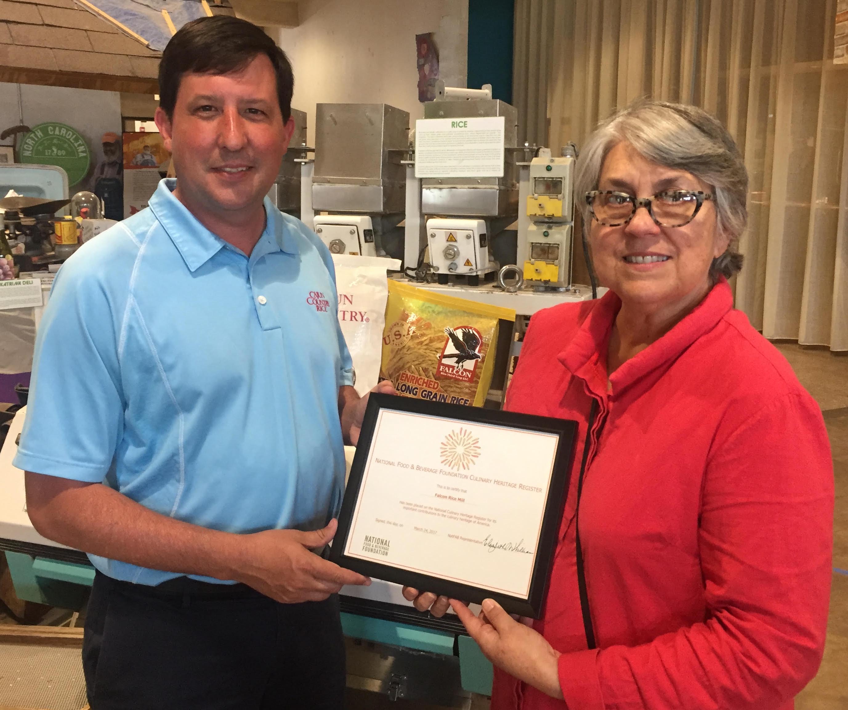 Falcon Rice Mill Owner Robert Trahan receives plaque from Culinary Heritage Museum