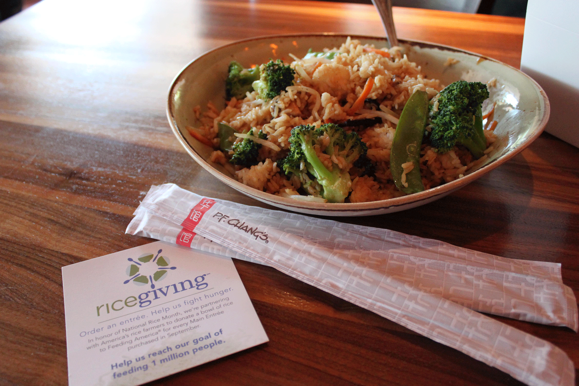 NRM-Staff-Luncheon,-PF-Changs, bowl of rice & veggies with chopsticks & promo sign