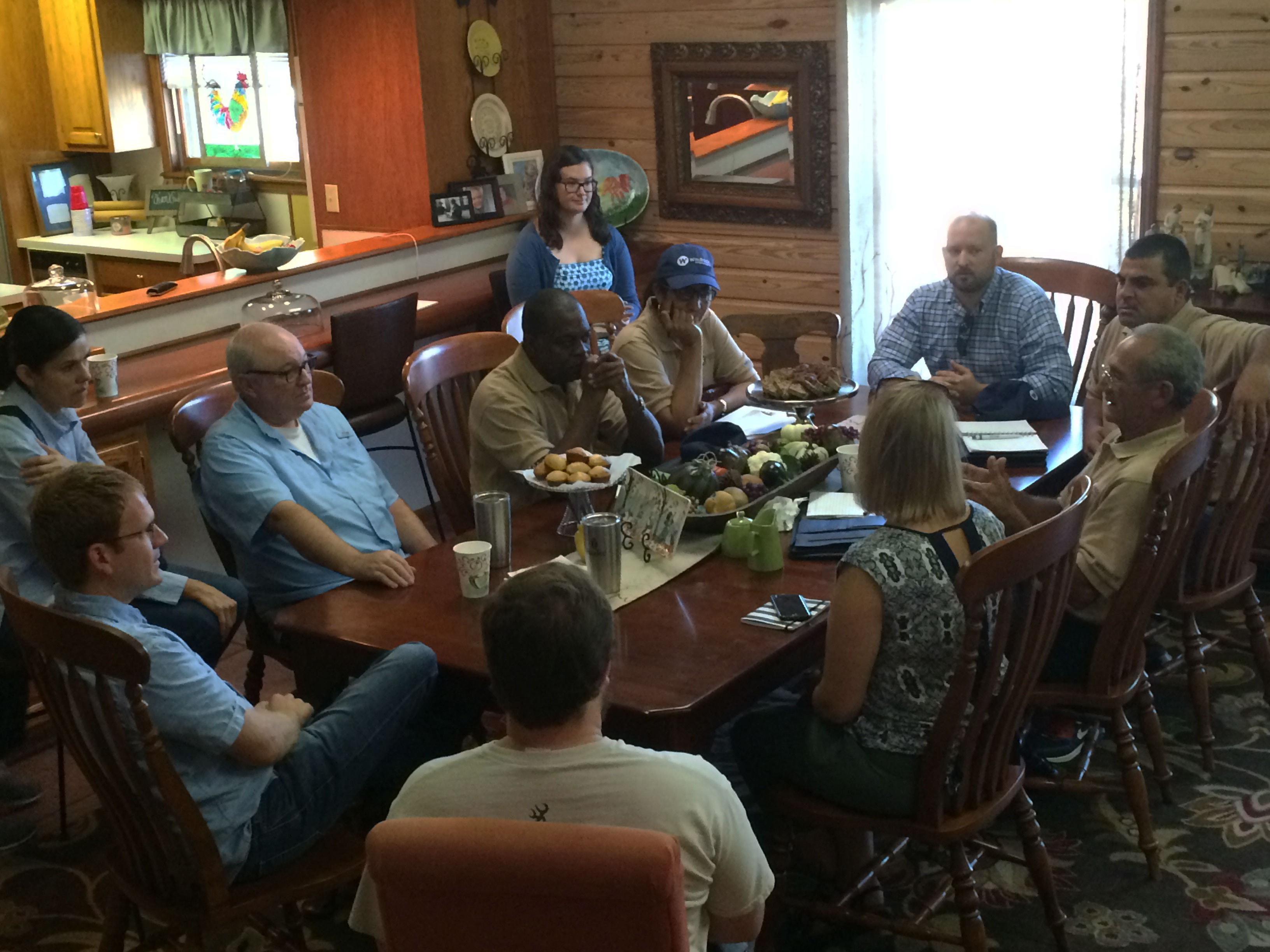 Cuban-Farmers visit it-AR-Rice-Country, seated at family dinner table