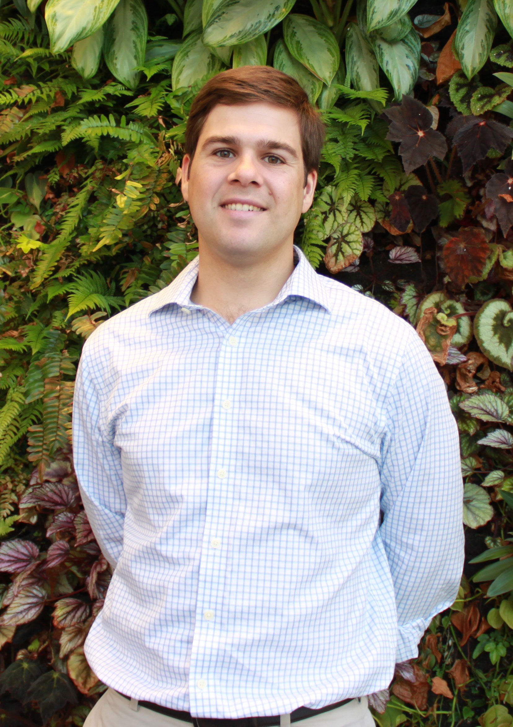 Headshot of USA Rice Manager of Government Affairs Frank Leach in front of living plant wall