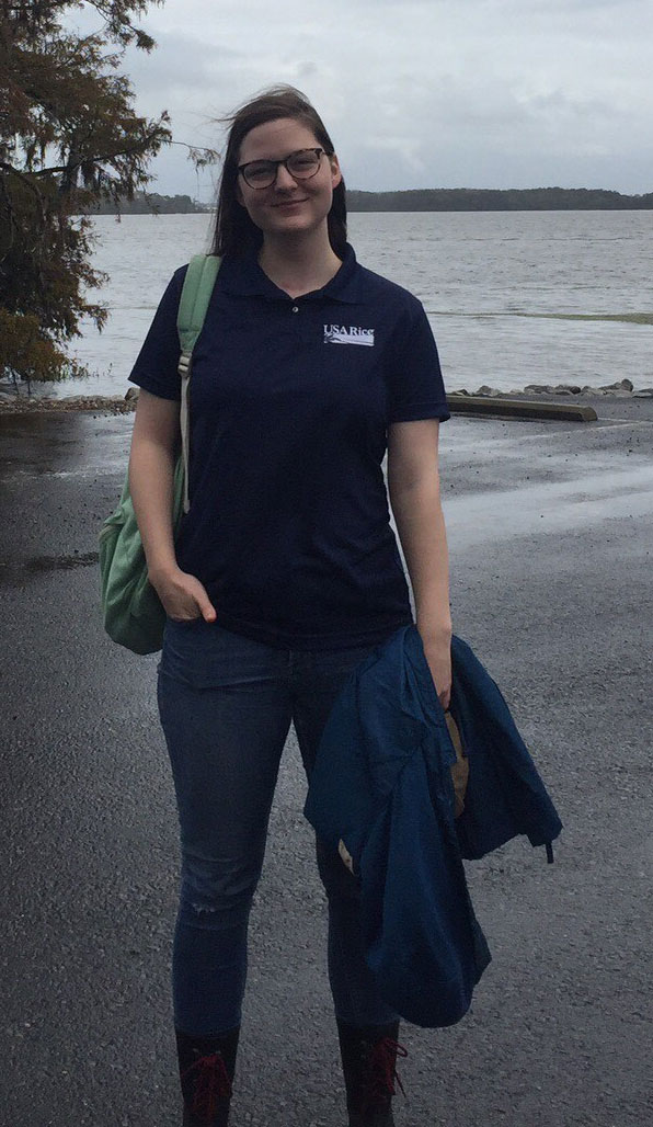 Lesley-Dixon standing near flooded rice field