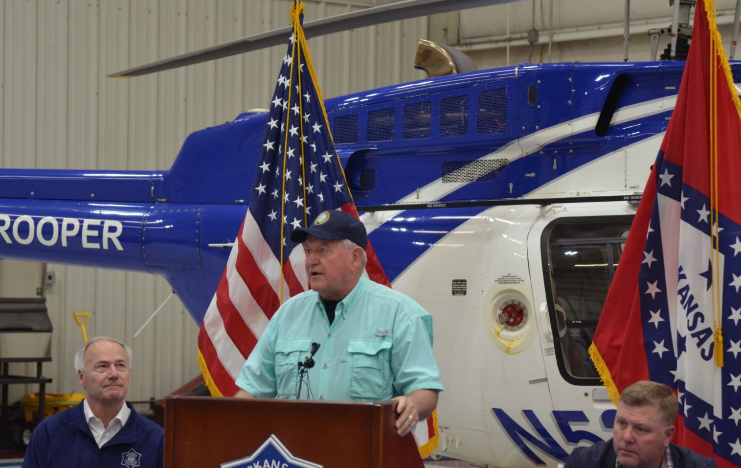 Secretary of Ag Sonny-Perdue-standing in front of rescue helicopter during press conference about 2017 AR flood
