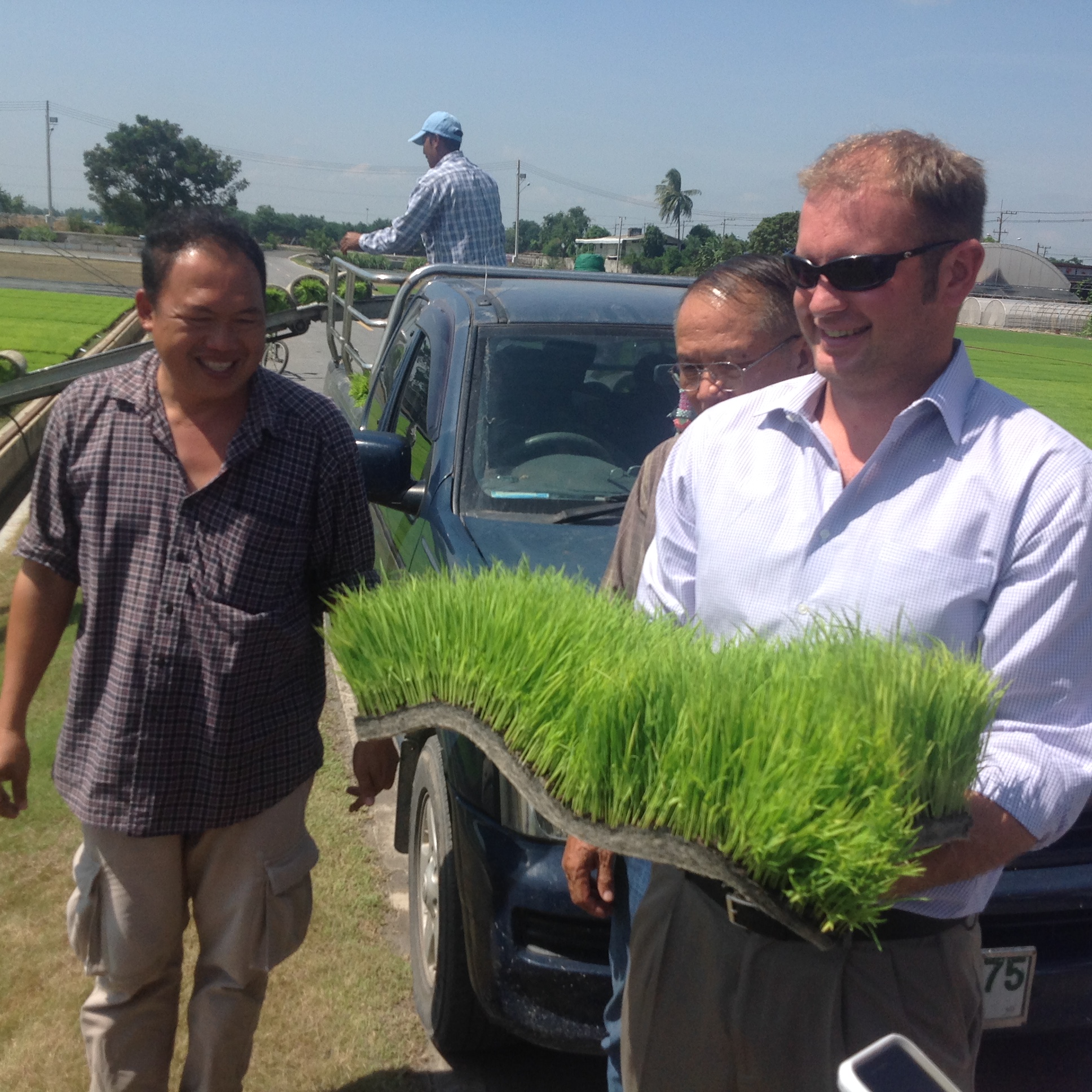 Tim Gertson holding rice research materials on Thailand trip