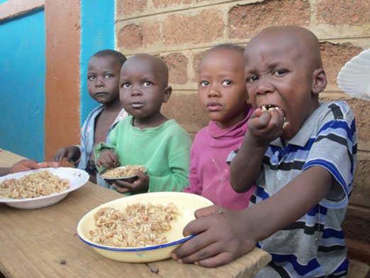 Children-Eating-Bowls-of-Rice,-Food-Aid