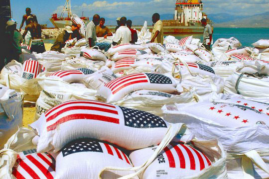 US rice-bags-with American flag being unloaded from a ship