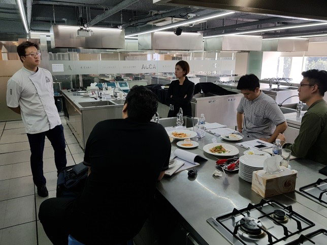 Chef in professional kitchen presents new menu ideas for South-Korea-Foodservice-program