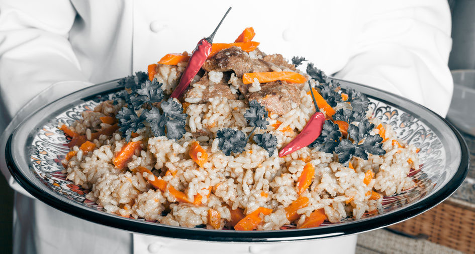 Tray full of Turkish-Pilaf held by a chef