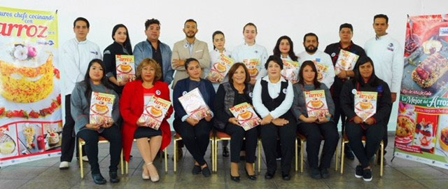 Group shot of chefs and instructors holding Mexican cookbook at launch party 2017