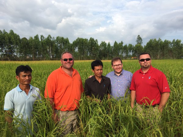 Leadership Class in Thailand- stand with local farmers in rice field