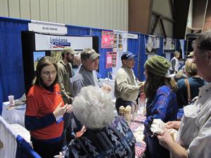 USA Rice booth at LA Ag Expo with crowds of people talking, examining products
