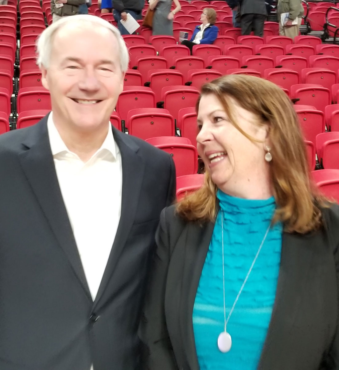 CEO Betsy Ward standing next to AR Gov-Asa Hutchinson