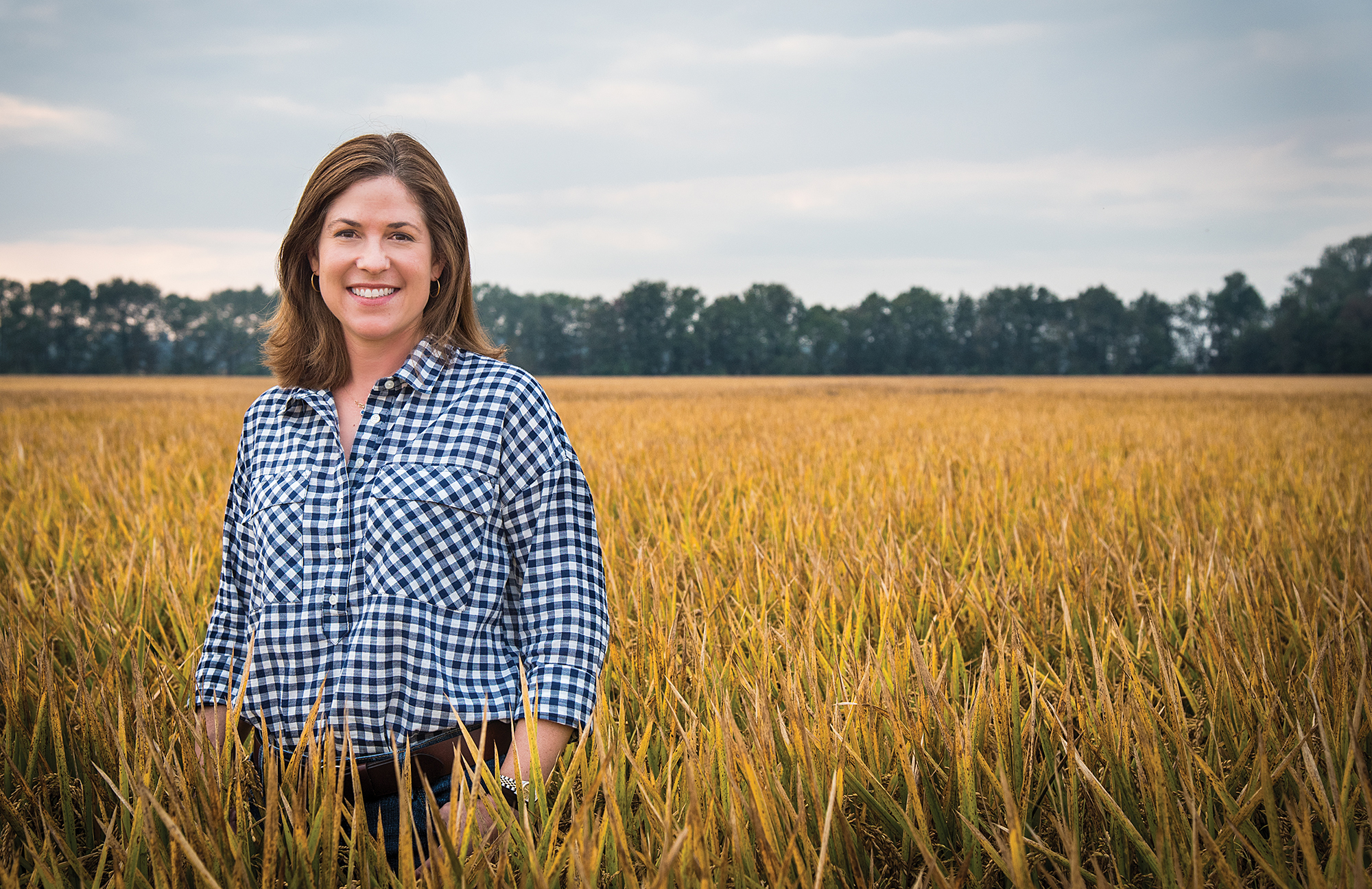 Jennifer James, standing waist-deep in her rice field