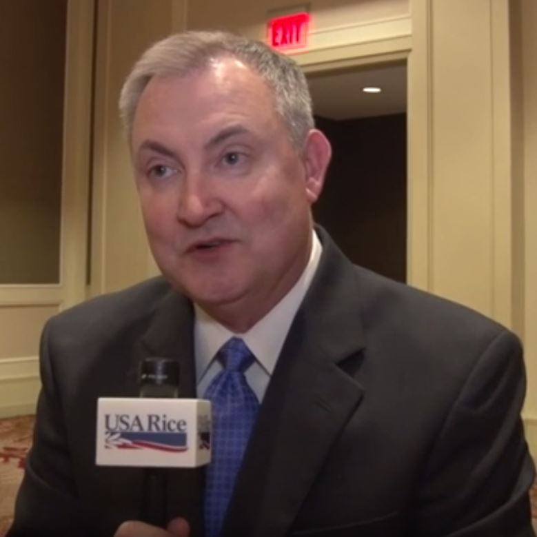 Keith Glover being interviewed, holding USA Rice microphone