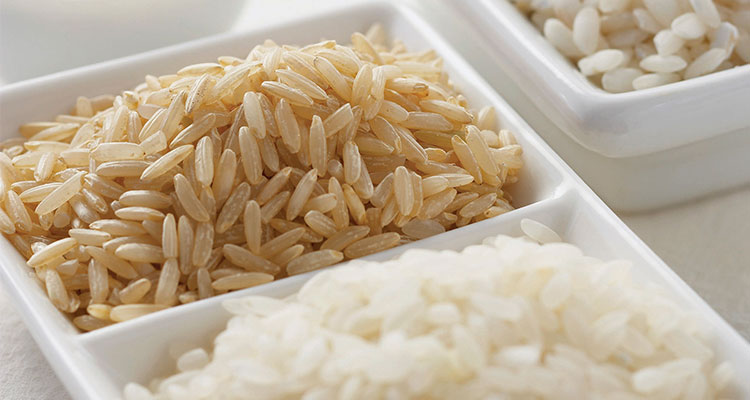 Rice in bowls Overhead view of different types of rice in wooden bowls.